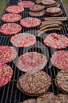 Burgers and sausages on the grill photo