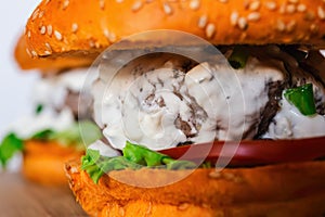 burgers with Sesame Buns on wooden board