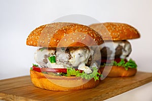 burgers with Sesame Buns on wooden board
