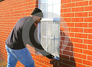 Burglar Breaking in Home Window