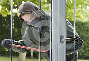 Burglar breaking in a house