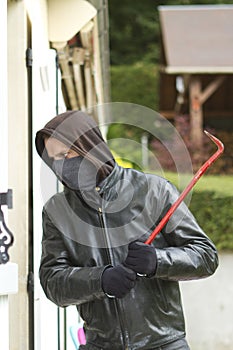 Burglar breaking in a house