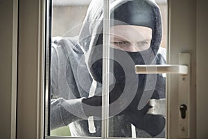 Burglar Breaking Into House By Forcing Door With Crowbar