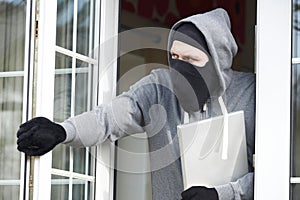 Burglar Breaking Into House And Stealing Laptop Computer