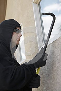 Burglar With Crowbar Breaking Into House