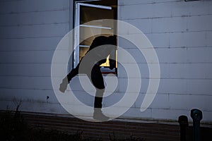 Burglar Entering In A House Through A Window