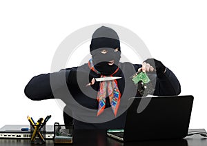 Burglar holding a knife and hard disk speaking on Skype photo