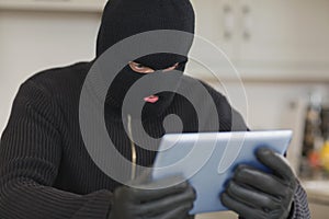 Burglar holding tablet pc