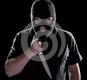 Burglar in mask holding knife