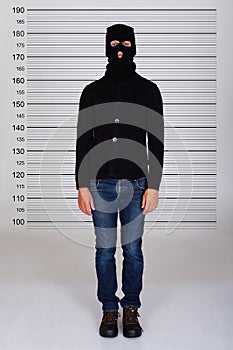 Burglar Standing Against Police Lineup photo