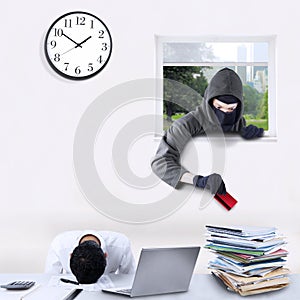 Burglar stealing credit card in office