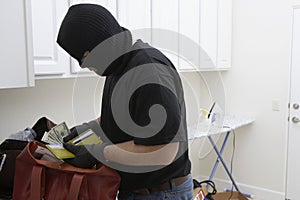 Burglar Stealing Money From House photo