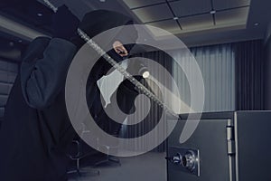 Burglar stealing a safe deposit box
