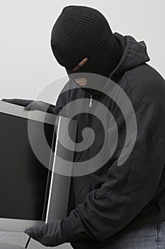 Burglar Stealing Television Set