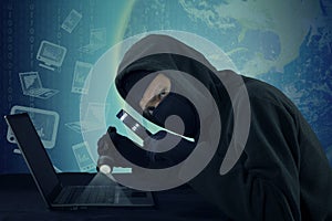 Burglar stealing user data on the laptop