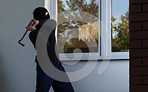 Burglar tries to smash a window