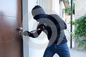 Burglar trying to force a door lock