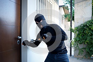 Burglar trying to force a door lock