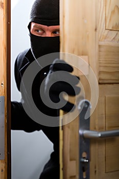 Burglary crime - burglar opening a door