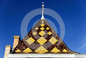 Burgundian tile - roof of the palace in the architectural style of Burgundy, region Beaujolais, France