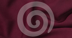 Burgundy fabric background. Burgundy cloth waves background texture.