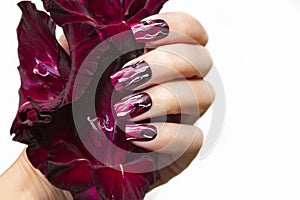 Burgundy manicure with gladiolus.