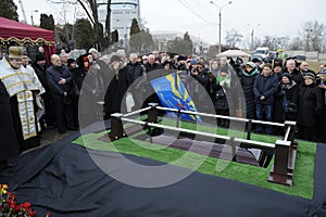 Burial service, relatives giving their last farewell to a late, cemetery