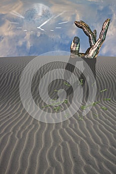 Buried sculpture of hand in desert with clock