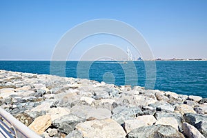 Burj Al Arab luxury hotel and Jumeirah Beach hotel in a sunny day in Dubai