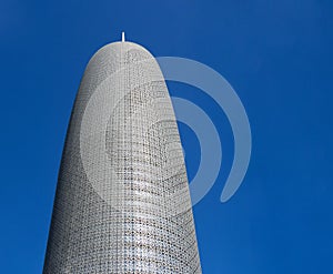 Burj Doha (Burj Qatar, Doha Tower) against clear blue sky, close up view