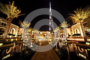 Burj Dubai, night Dubai street with palms and pool