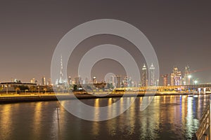 Burj Khalifa with lake or river and bridge in Dubai Downtown skyline, United Arab Emirates or UAE. Financial district and business