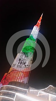 Burj Khalifa at night with projected slogan: `poverty is the worst form of violence`