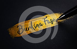 Burkina Faso Handwriting Text on Golden Paint Brush Stroke
