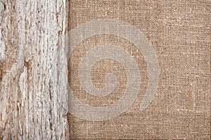 Burlap background bordered by old wood