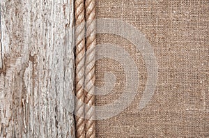 Burlap background bordered by rope and old wood