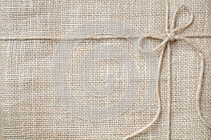 Burlap background tie with rustic burlap twine, natural product