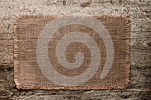 Burlap canvas with lacerate edges on old grunge