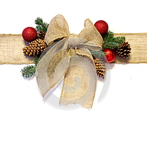 Burlap Christmas Bow, and Ornaments with Pinecones Isolated on W