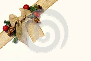 Burlap Christmas Bow, and Ornaments with Pinecones Isolated on W