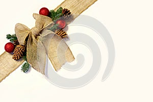 Burlap Christmas Bow, and Ornaments with Pinecones Isolated on W photo