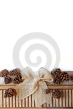 Burlap Christmas Bow and Pinecones Isolated on White Background