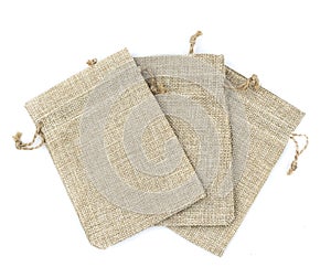 Burlap gift bags on isolated white background