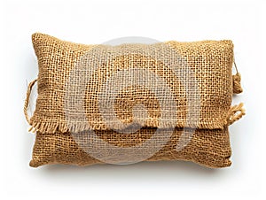 A burlap pillow with fringes on a white background photo