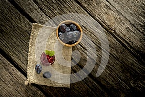 Burlap sac lying over rustic textured wooden desk with glass jar