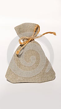 Burlap sack with rope tie on white background