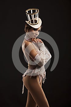 Burlesque dancer in white dress with hat