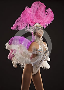 Burlesque dancer in white dress with pink plumage