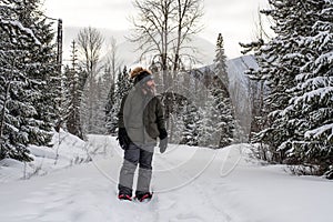 Burly Outdoorsman Snoeshoeing in the Forest