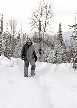 Burly Outdoorsman Snoeshoeing in the Forest